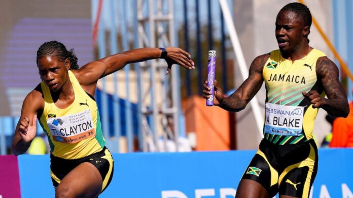 Ackeem Blake hands the baton to Tina Clayton in the mixed 4x100m heats in Gaborone (© World Athletics CameraChristel Saneh)